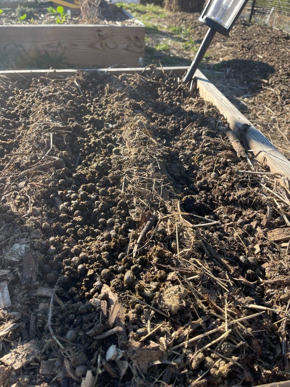 Composted rabbit manure in raised garden bed