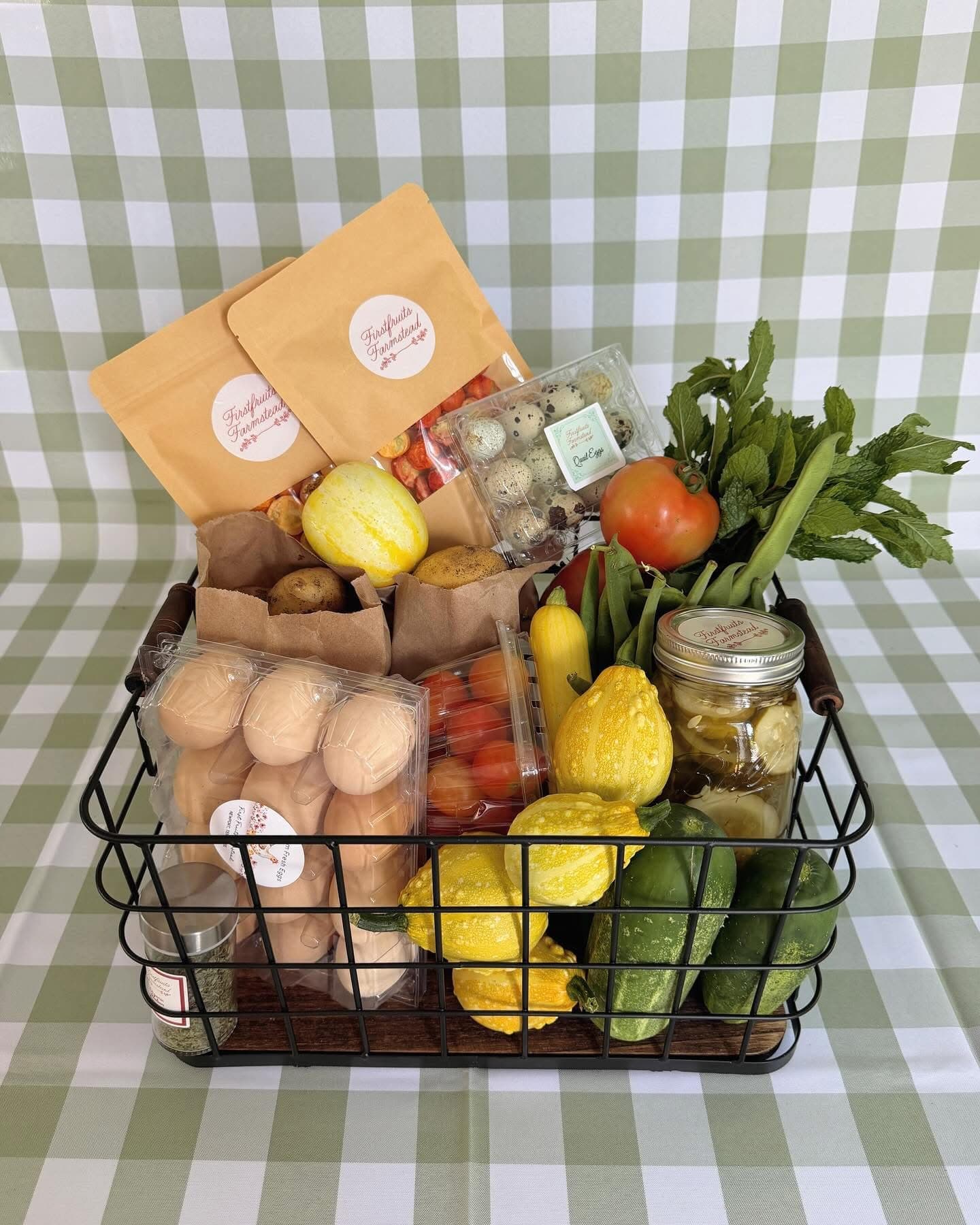 Basket of Firstfruits Farmstead farm-fresh eggs, quail eggs, squash, cucumbers, tomatoes, herbs, and pickles